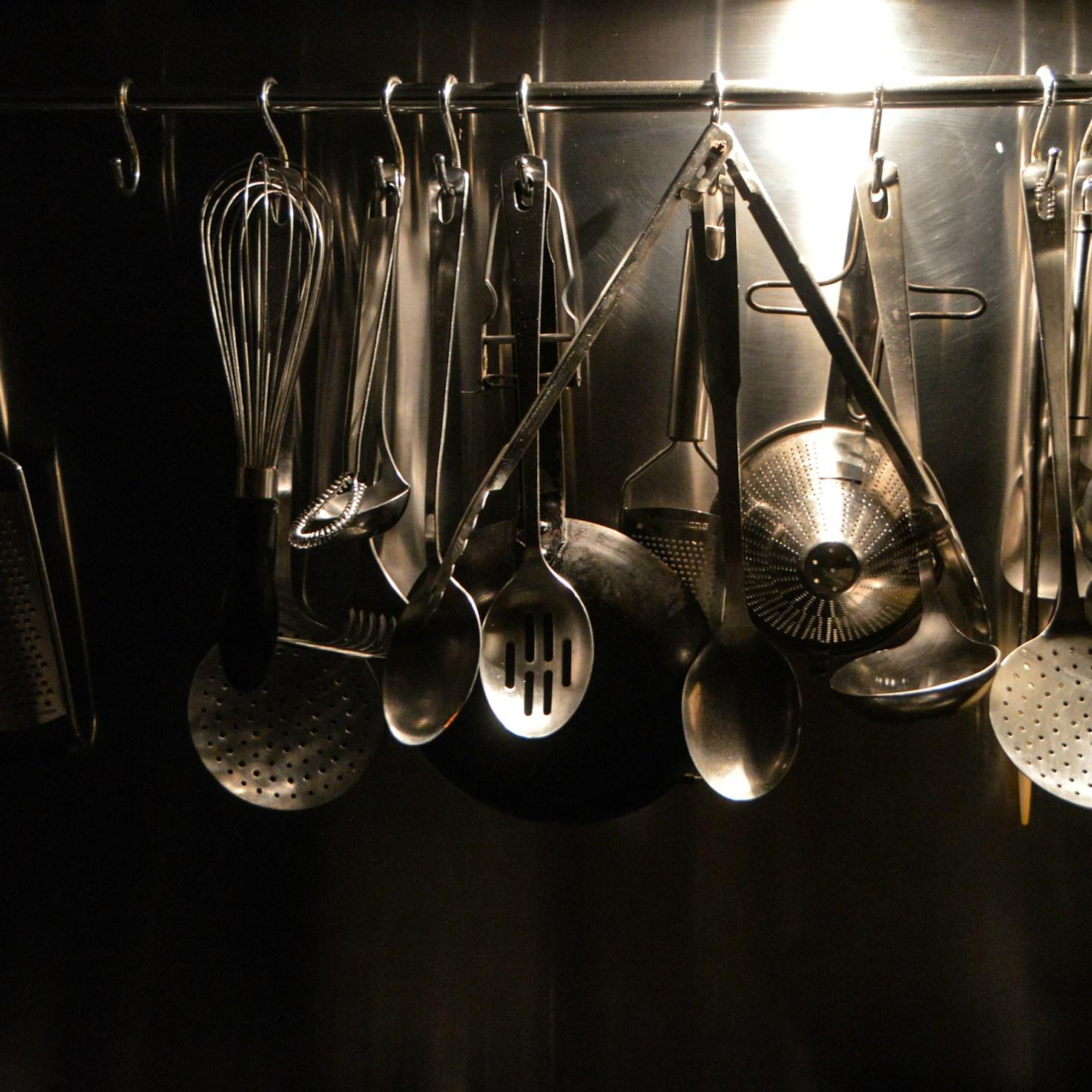 Community members collaborating in a modern kitchen, sharing recipes and cooking techniques